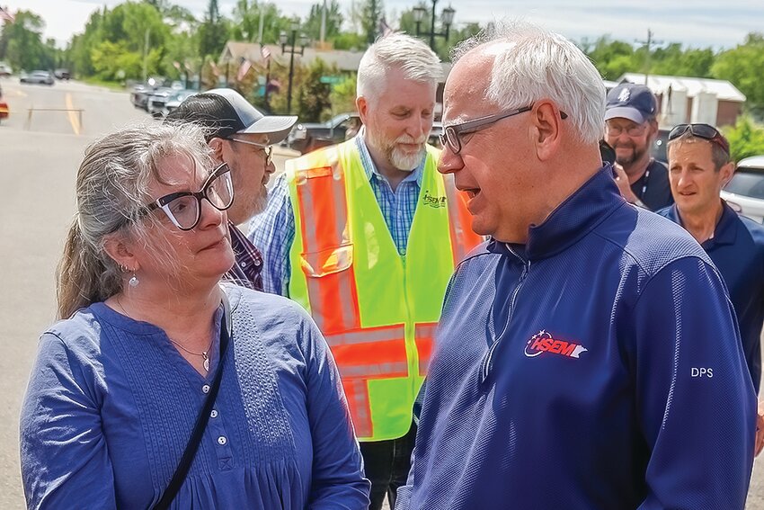 Gov. Tim Walz talks with Theresa Drift, whose home was   flooded, during his recent visit to Cook.