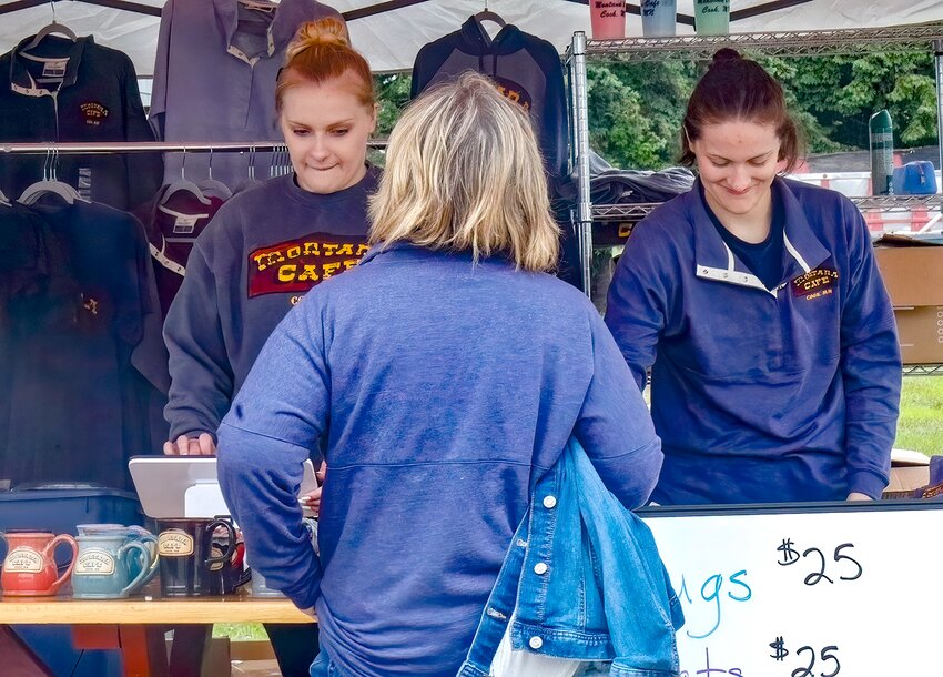 Krystal Brodeen, left, and Megan Brodeen sell Montana Caf&eacute; merchandise on Friday from a tent outside the building. The site was shut down and the building closed that afternoon after an inspection indicated the building could possibly collapse. Update: The building was cleared for Strong and others to re-enter after an inspection earlier this week.