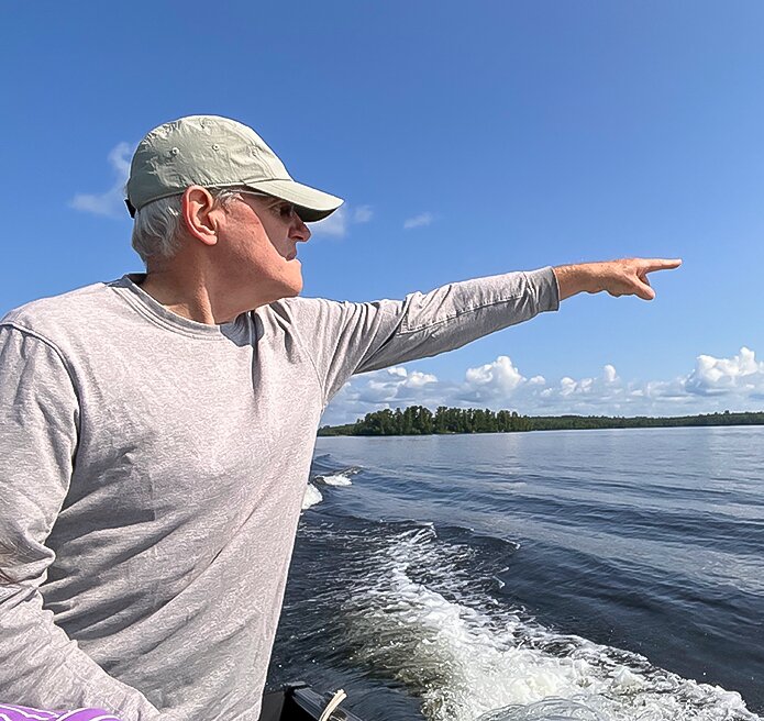 Don Eisenhauer, a Vermilion Lake Association volunteer points out a loon during the July 8 loon count. Spotters sighted a total of 193 loons.