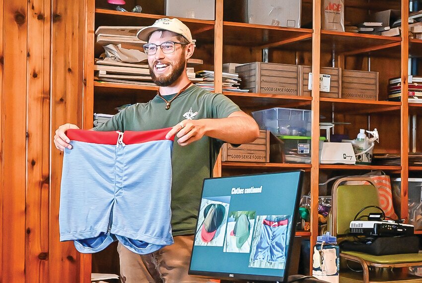 Ozzie Reif showing his hand-made hiking gear at the Ely Folk School on Monday. Reif is hiking 110 miles from Ely to Grand Marais. He plans to arrive at Grand Marais in time to give a talk this Friday, Aug. 30.