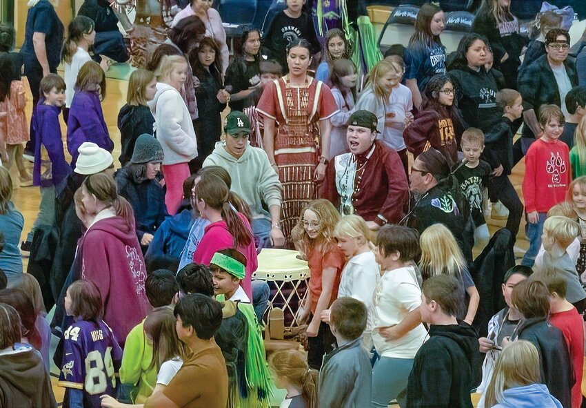 Elementary students dance around the Vermilion Singer&rsquo;s drum.