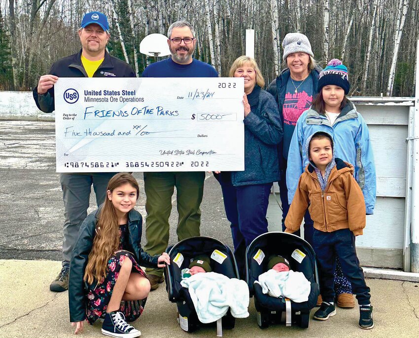 Mike Bakk, Director, Operational Readiness, Minnesota Ore Operations - Keetac, presents a $5,000 donation for the pickleball project to Friends of the Parks members Steve Kajala, Jeannie Taylor and Val Annen, along with future skaters and pickleball players Lucy Hed, Lily and Remy Reing, and Maverick and Hendrix Reing.