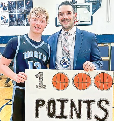 North Woods senior guard Louie Panichi   celebrates his scoring   milestone with Coach Andrew Jugovich after Friday&rsquo;s win against Duluth Marshall.