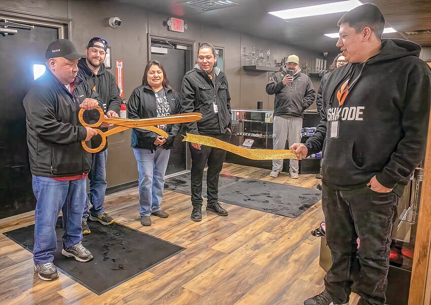Interim Bois Forte Tribal Council Chairman Shane Drift cuts the ribbon to signal the opening of  the Ishkode cannabis dispensary.