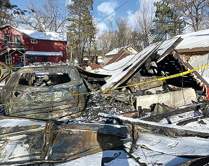 Scorched remains of the garage and vehicles owned by Dave Wanless and Laura Garofalo after a   suspicious fire last January.