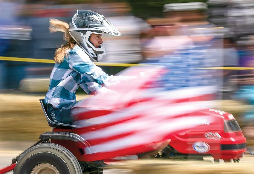 Salena Dancker crosses the finish line in the top spot in the modified lawnmower division.