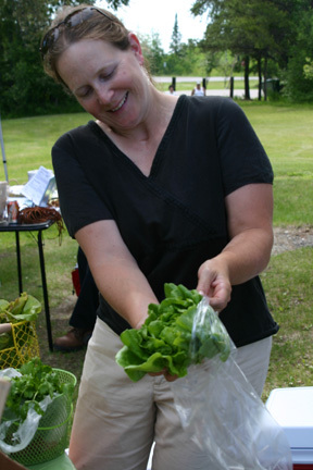 Janna Goerdt, of Embarrass, bags up some lettuce from her farm.