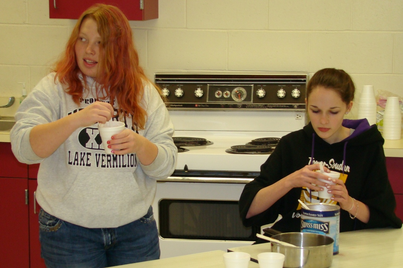 Paige and Abby stir the hot chocolate.
