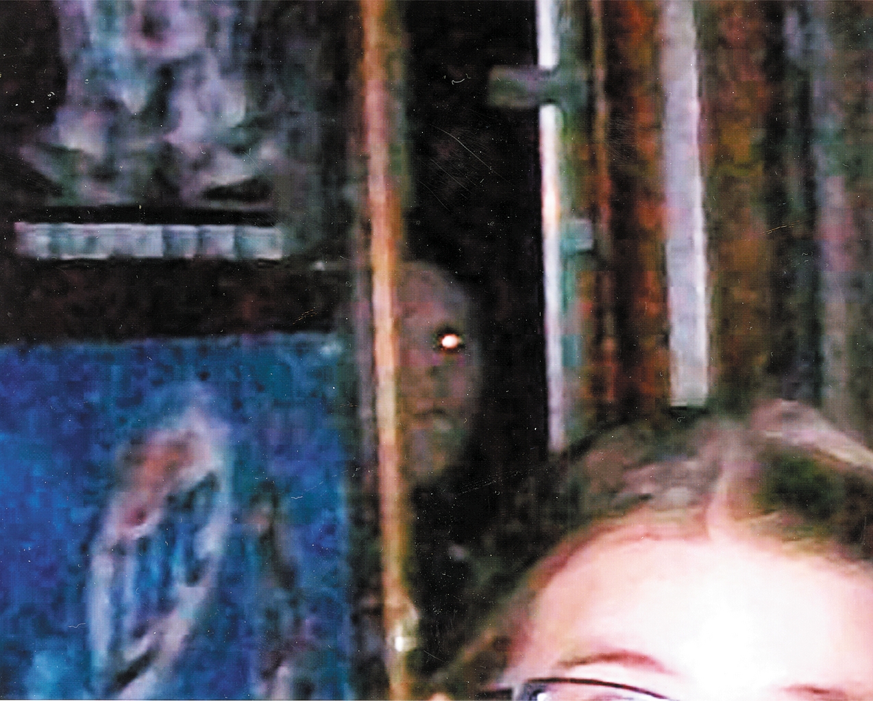 An enlargement of the photo better shows the ghostly face that appeared in the doorway of the Ely Bowling Alley. The apparition has prompted speculation that the building may be haunted.
