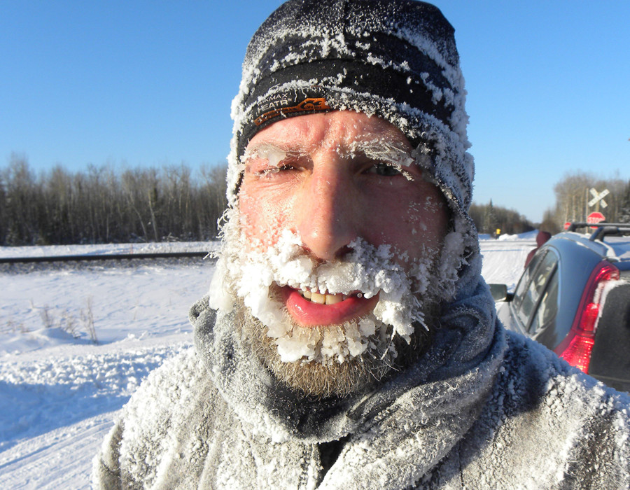 Minnesotan David Gray, smiles through an icy beard during a quick breather on the way. Gray finished fourth in the race, with a time of 25 hours, 57 minutes.