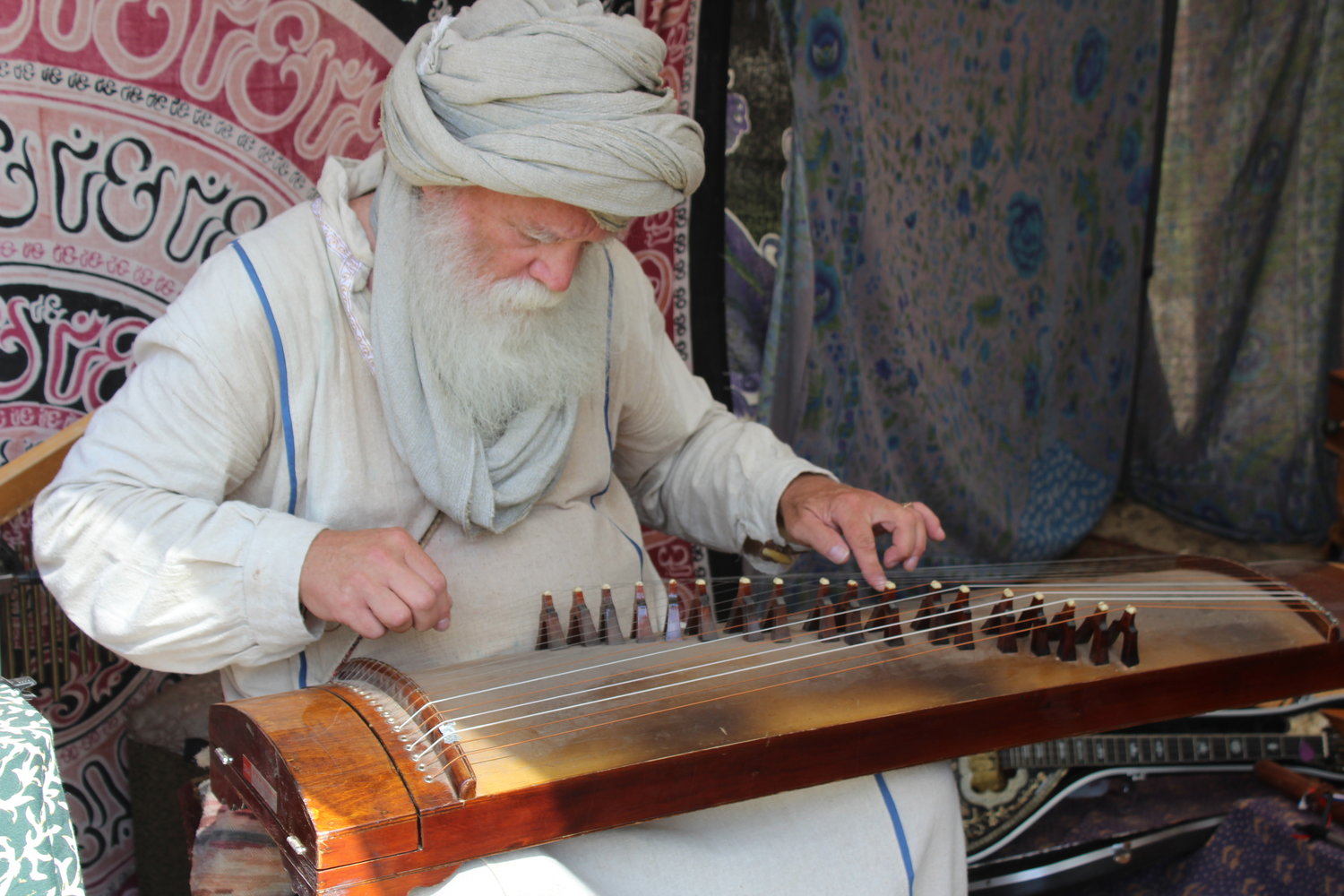 Mystic and musician Mustafa Ali performs on one of the dozens of instruments that he has gathered from around the world.
