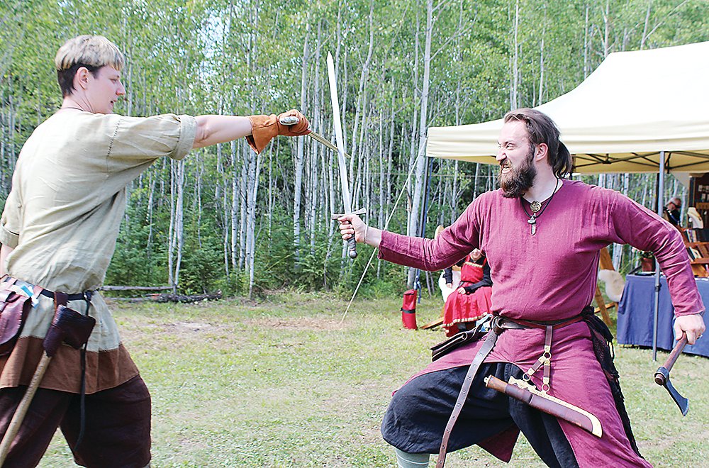 Viking re-enactors Rav Torsdotter (l) and Fingar Gulbrandson battle with swords.