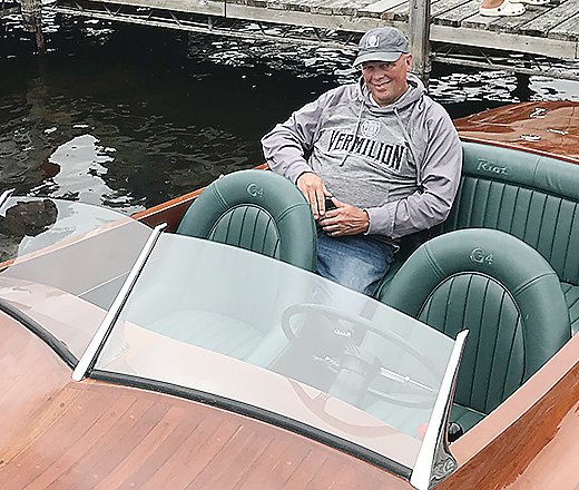 Chris Bullen relaxes in the back of his replica of a classic 1924 
speedboat.