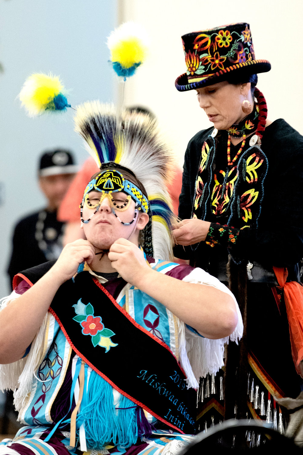 Gretchen Morris makes final adjustments to her son Dillion’s outfit prior to Sunday's grand entry at the Bois Forte Midwinter Pow Wow at Nett Lake.