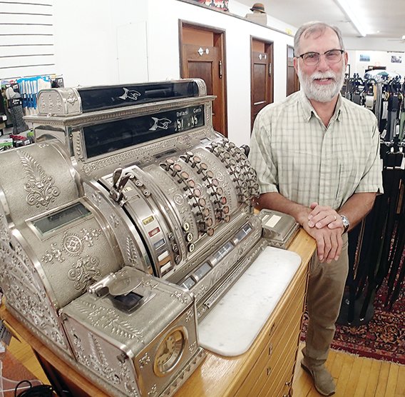John Mills still uses a vintage cash register in the J.D. Mills Company clothing store on Sheridan Steet in Ely.