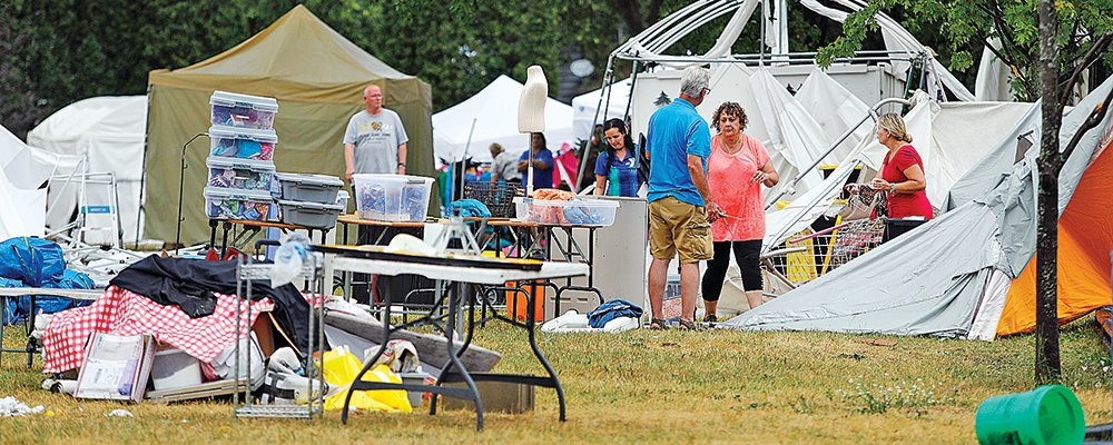 Blueberry/Art Festival vendors walked around Whiteside Park in stunned silence minutes after a fierce storm hit the Ely area Friday night