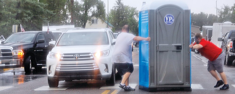 Community members returned a porta-potty that blew down the street, middle.