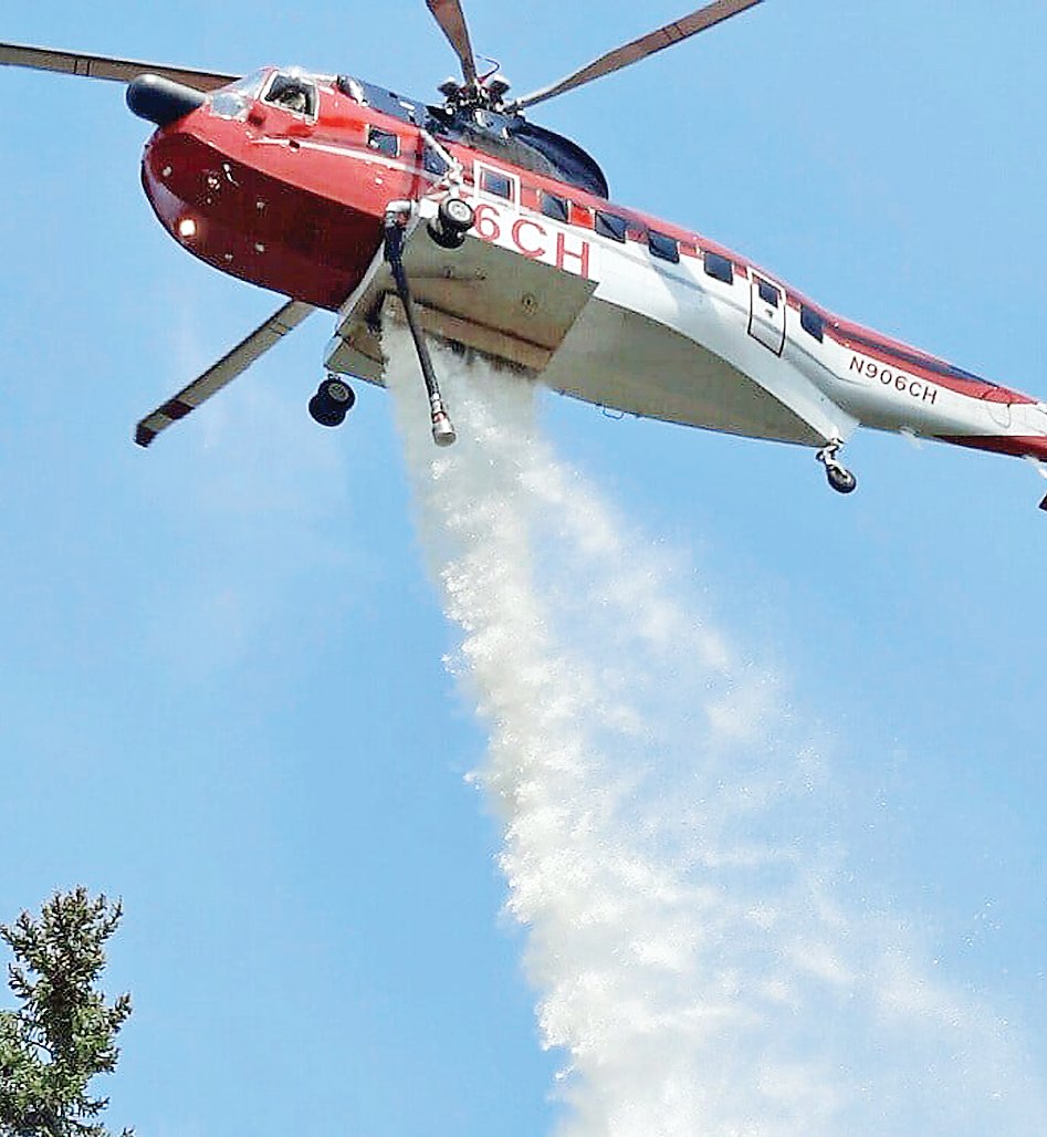 A helicopter dumps a load of water on the Phantom Fire, about 10 miles west of Ely, on Sunday.