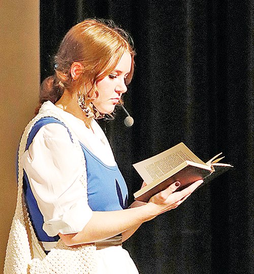Sidney Marshall, as Belle, reads to the Beast.