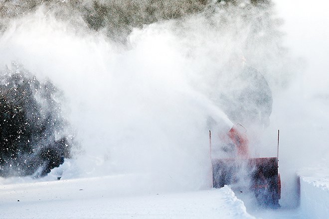 An Ely snowblower operator fights though the wind-driven snow Monday morning while clearing his sidewalk.
