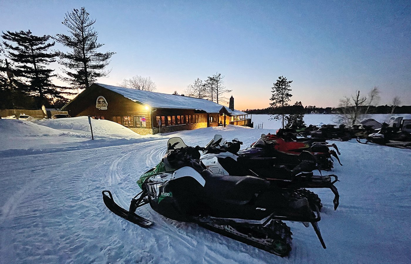 The sun sets over Lake Vermilion last Friday at the Bayview Bar and Grill and a parking lot full of snowmobiles.