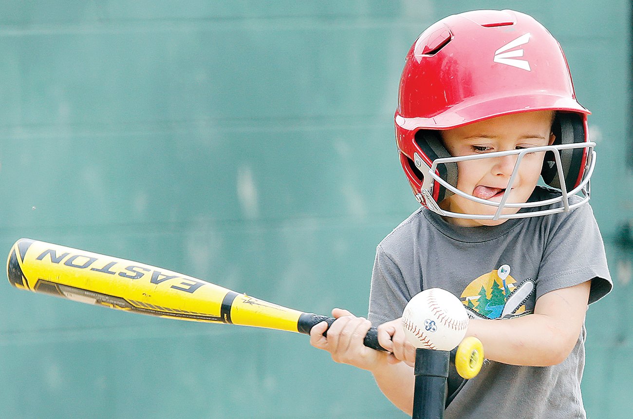 Hollace Fenske and other Ely-area youth 
gather on Wednesdays and Saturdays at the Ely Little League Field for T-Ball action.