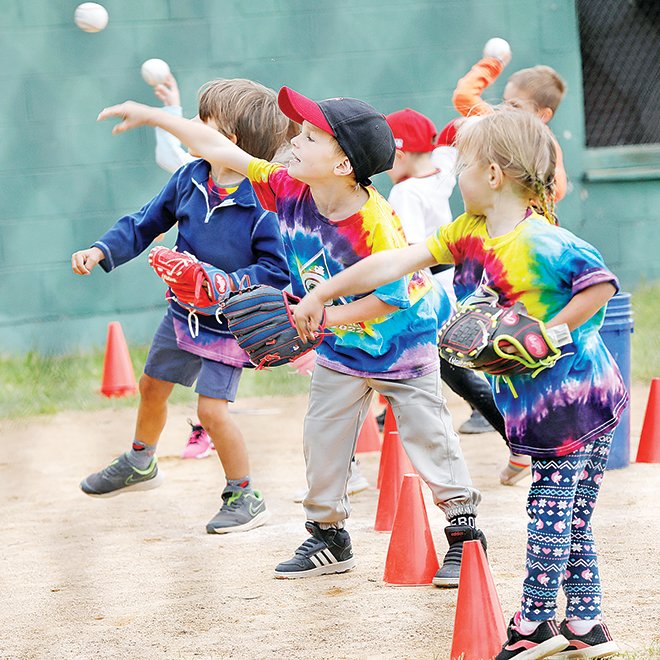A group of youngsters give their throwing arms a workout.