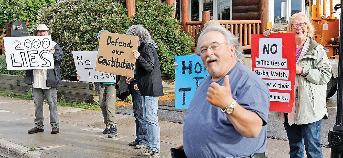 Ely resident Mike Banovetz gave a thumbs up Saturday morning as he engaged with protesters across the street from Ely’s Historic State Theater prior to the showing of “2000 Mules,” a film 
purporting to document claims of voter fraud during the 2020 election.