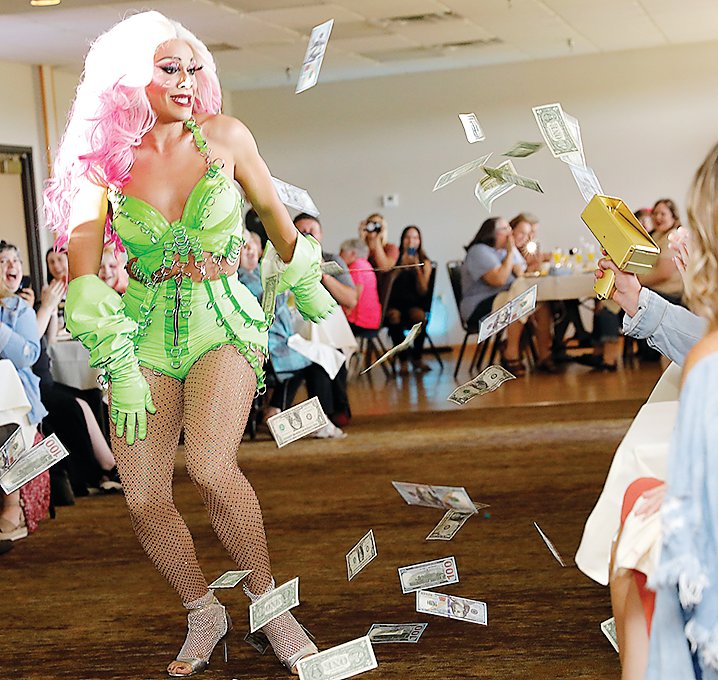 Performer Onya Deek attracts a hefty shower of cash as she makes her way through the room. The event raised thousands of dollars for OutFront Minnesota.