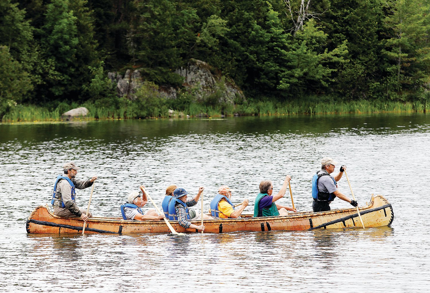Eric Simula, in the stern, and other paddlers hit the water at Semer’s Park Sunday afternoon for the maiden voyage of the Burntside, a 20-foot Ojibwe-style birch bark canoe made at the Ely Folk School.