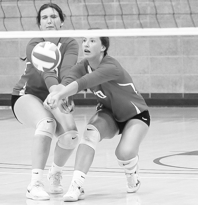 Kate and Rachel Coughlin 
combine on a set assist during 
Tuesday’s game in Ely.