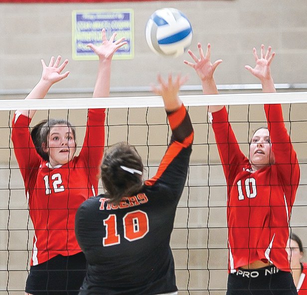 Ely’s Lilli Rechichi and Kate Coughlin team up to block a shot during last Thursday’s game with Cherry.