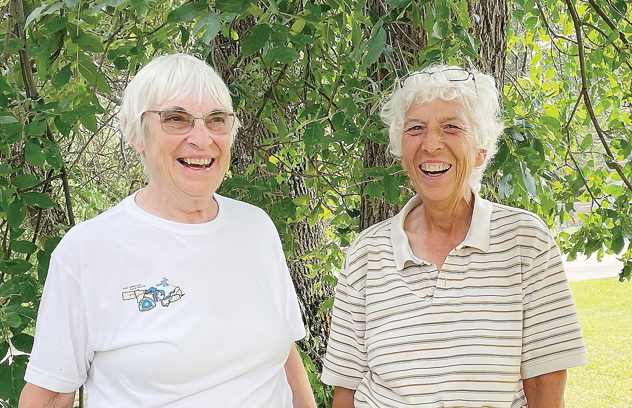 Joan Young (r) and her friend and trail helper Marie Altenau were all smiles as they stopped by the Timberjay 
office earlier this month. Young, who lives in Michigan, is working on her second full traverse of the North Country Trail.