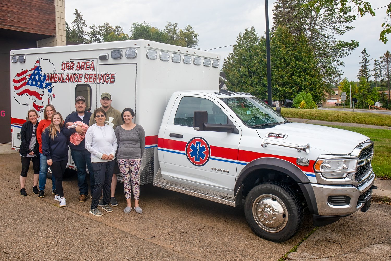 Members of the Orr Ambulance Services proudly show off the replacement for their nine-year-old ambulance, a brand-new unit that will improve patient and EMT experiences.