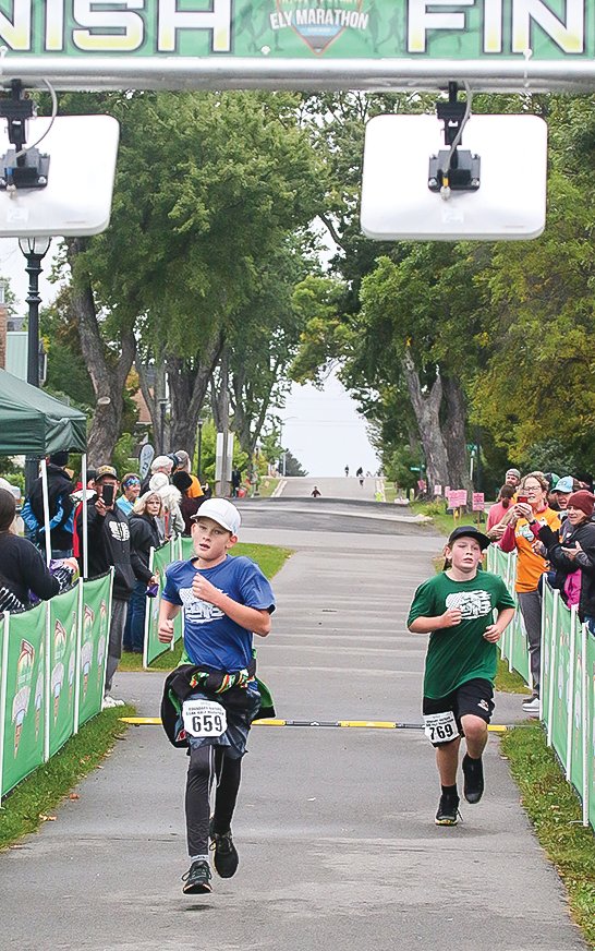 Ely sixth graders Henry Fetterer and Parker Niskala look strong heading into the finish of the half marathon at the 2:55 mark.