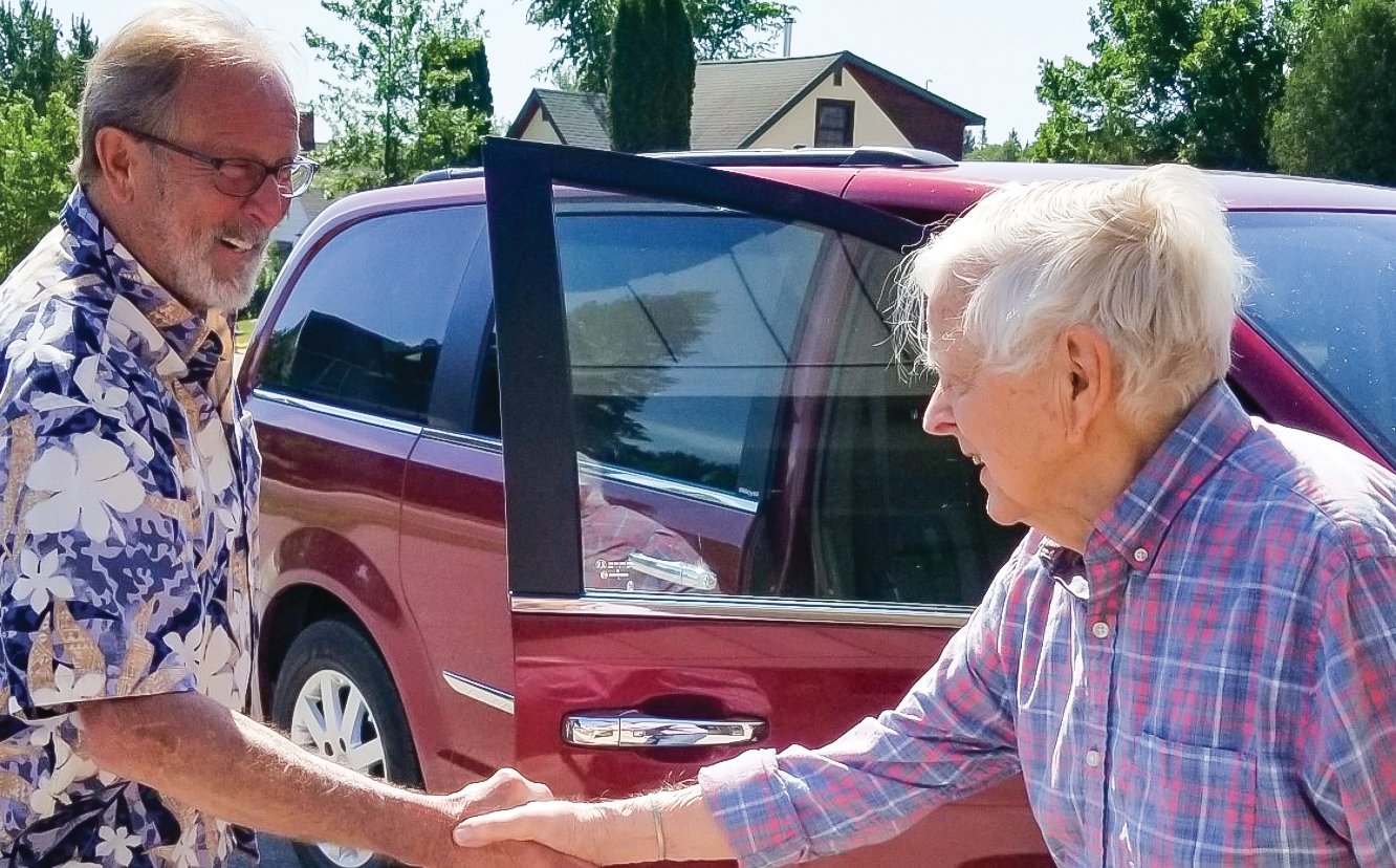 Larry Lozar, a volunteer driver with Northwoods Partners, picks up Ely senior Jim Orcutt to help run an errand.