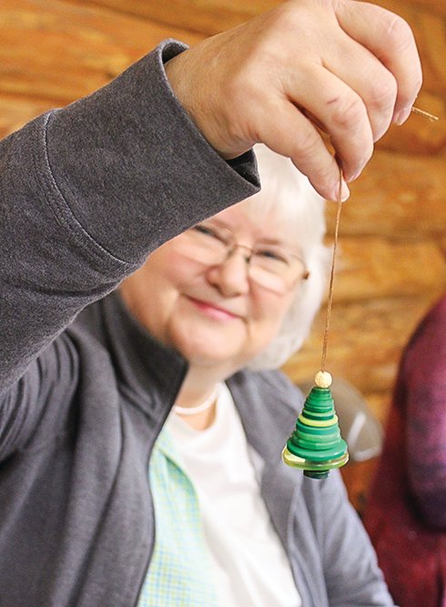 Judy Boyd, 
of Embarrass, displays one of the “button tree” ornaments she had on display at Timber Hall during the pancake breakfast.