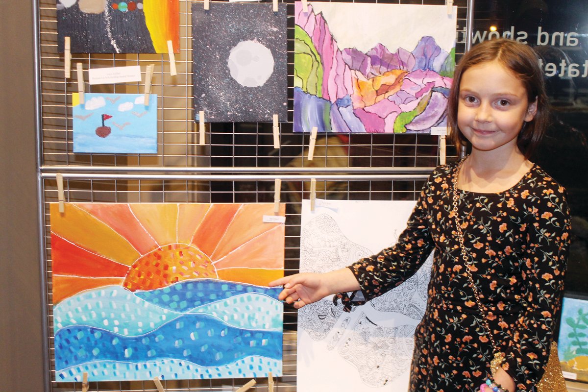 Suvi Kari shows off her art on display at the NLAA November art show at Ely’s Historic State Theater.