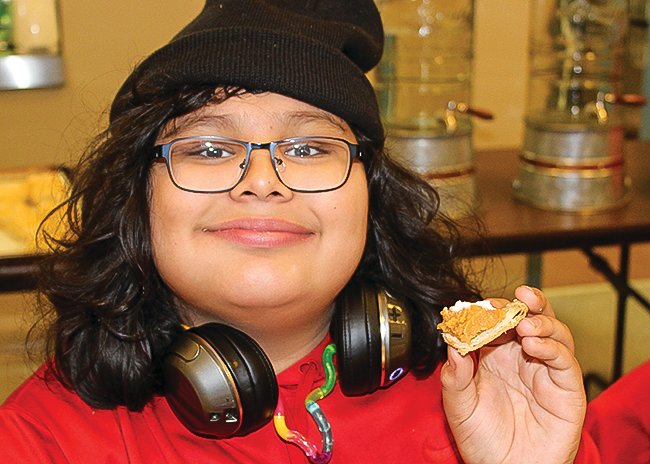 Student Kai Contreras-Pieratos shows off the last remaining bite or two of his piece of pie.