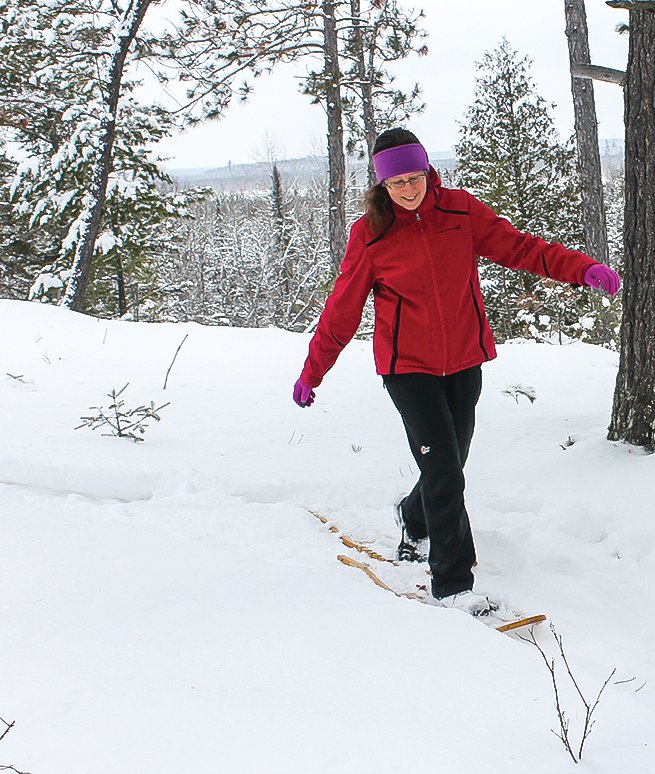 Jodi works her way along our snowshoe trail on a ridge overlooking the Lost Lake Swamp.