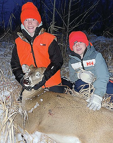 Croy Colbert and his little brother Canon with Croy’s deer.