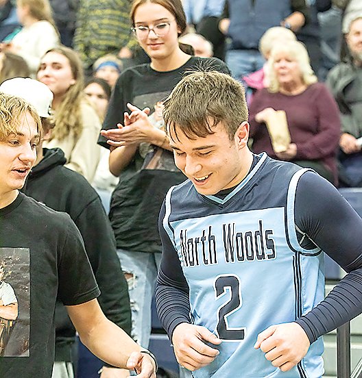 Jared 
Chiabotti smiles as he returns from the stands after 
collecting hugs from family and friends after 
scoring his 1,000th point early in 
Tuesday’s contest with Bigfork.