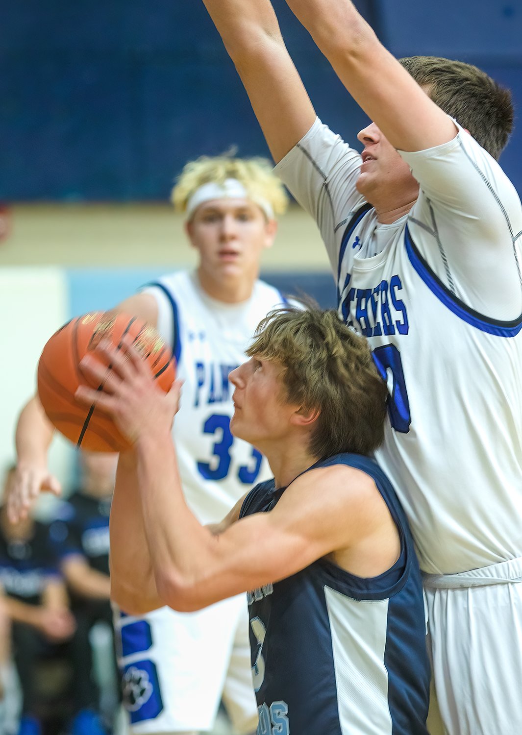 The Grizzlies' Jonah Burnett ball fakes before going up for a shot against 6'10" Austin Josephson of South Ridge. Burnett has been on a scoring tear the first two games of the season, nailing 22 points against the Panthers and 37 against Bigfork.