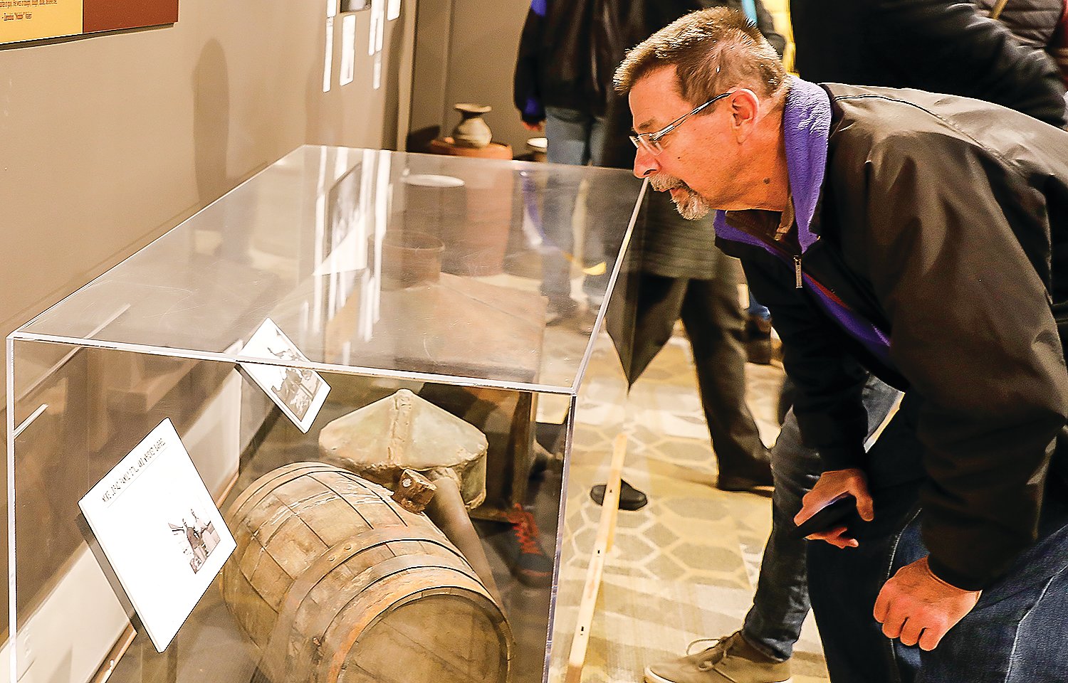 Joe Lopac, of Mt. Iron, takes a close look at a still owned and operated by his grandfather during Prohibition.