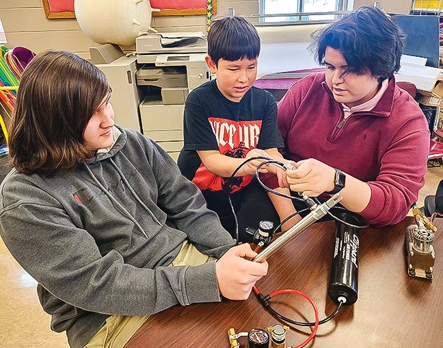 Robotics students did a demonstration at Tower-Soudan Elementary earlier this month. Pictured are (l-r) Ian Sunsdahl, Raymond Boshey, and Owen Koivisto.