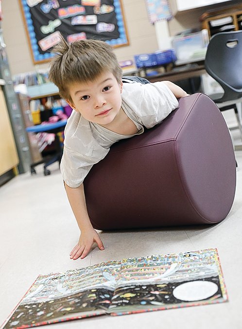 Neiko Stellmach is content on his rolling chair, part of an effort to allow students more opportunity for movement during the school day.