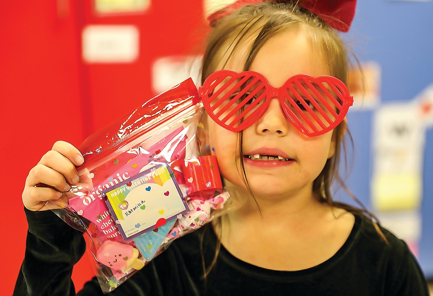 Karmina Chosa, with her heart glasses, shows off her Valentine’s Day loot.