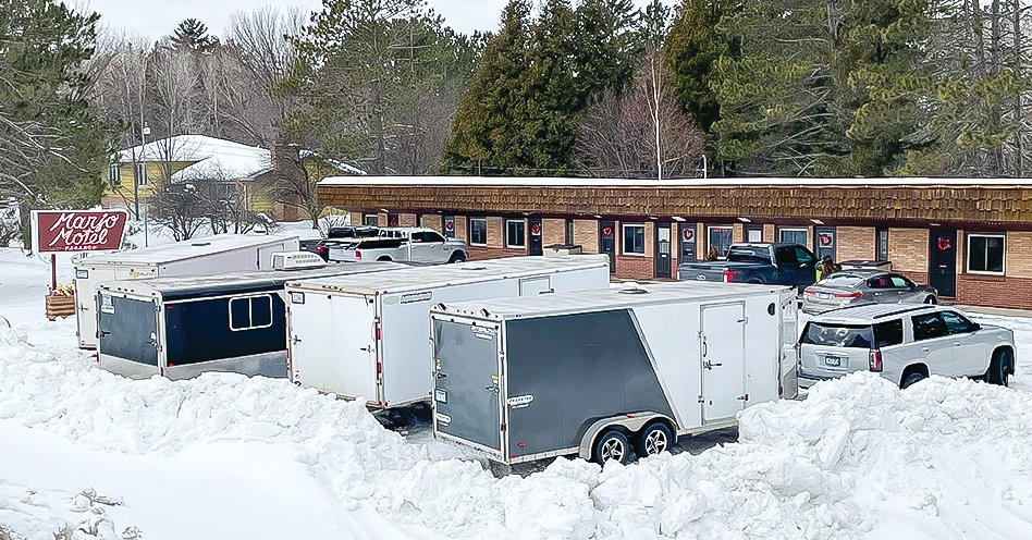 Large snowmobile trailers pack the parking lot at the Marjo Motel in Tower.