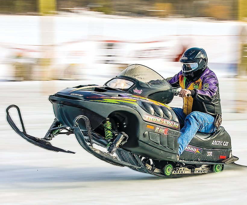 A stock sled racer lifts his skis during a fast takeoff during Saturday’s 
competition.
