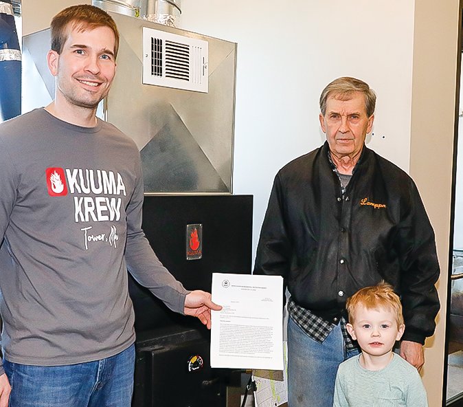 Three generations of the Lamppa family 
pose with the recertification letter the company received March 1. Pictured are Garrett Lamppa, Daryl Lamppa, and Garrett’s three-year-old son Leif Herbert Lamppa.